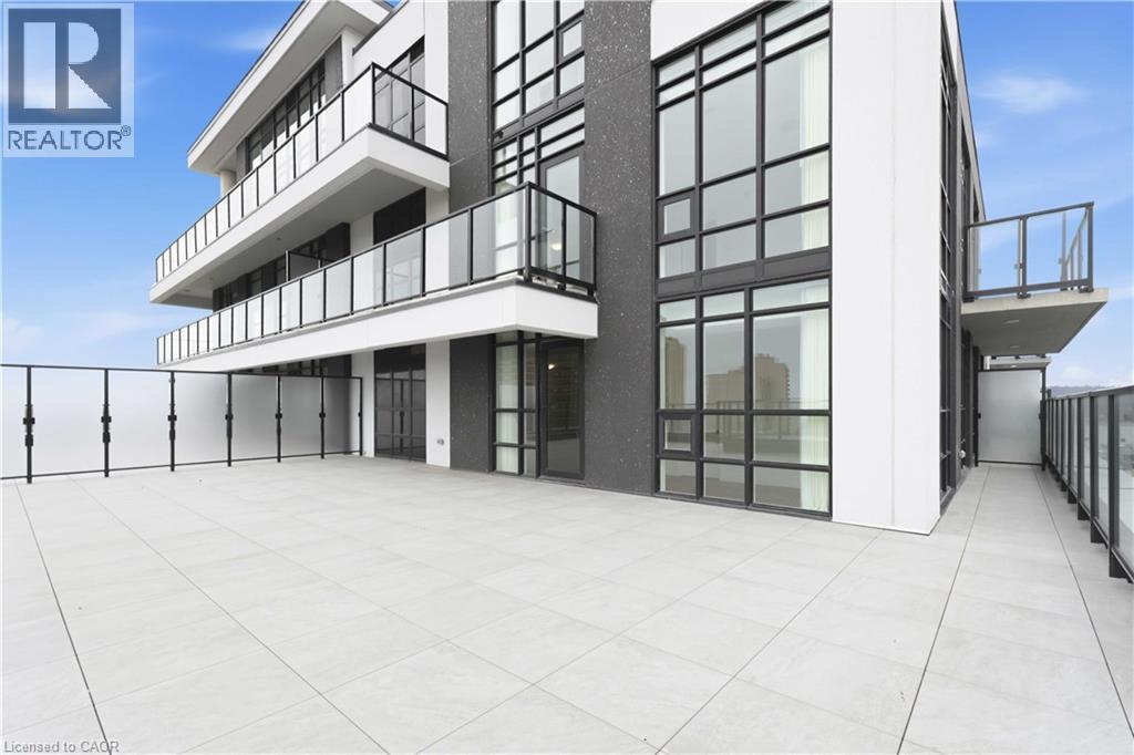 A modern building with a balcony and glass windows.