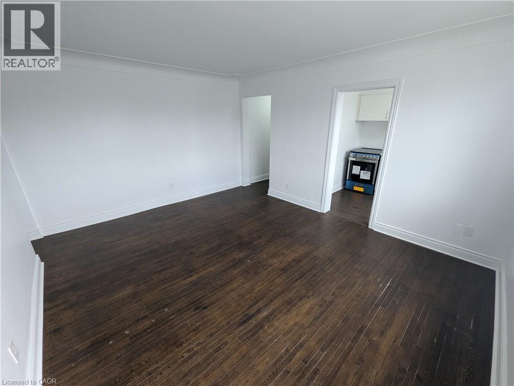 A room with wooden flooring and white walls.