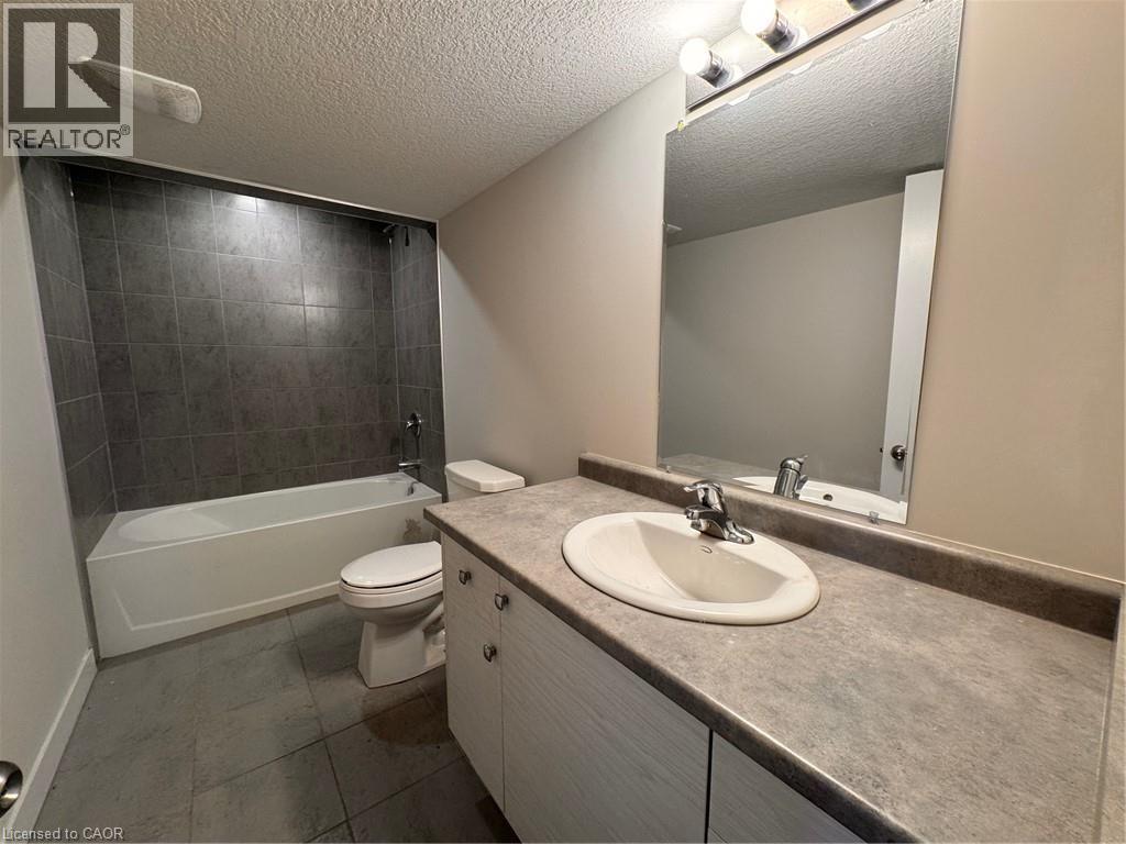 A bathroom with a sink, toilet, and bathtub.