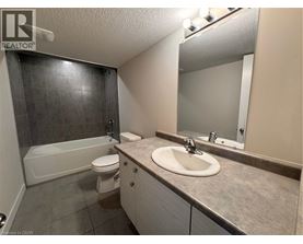 A bathroom with a sink, toilet, and bathtub.