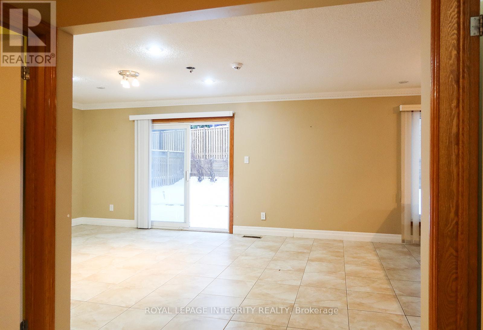 A room with a sliding glass door leading outside.