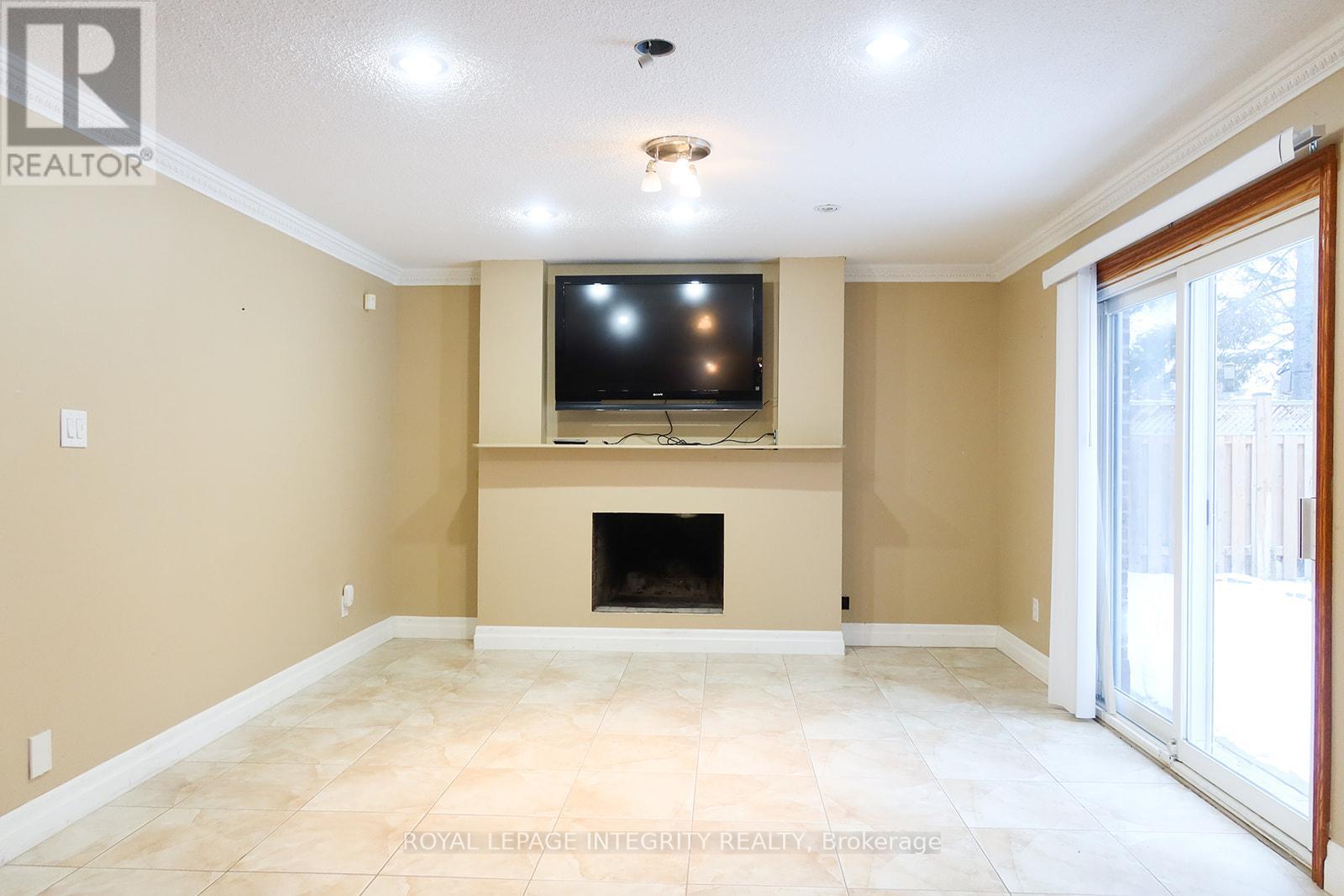 A living room with a fireplace and a television.