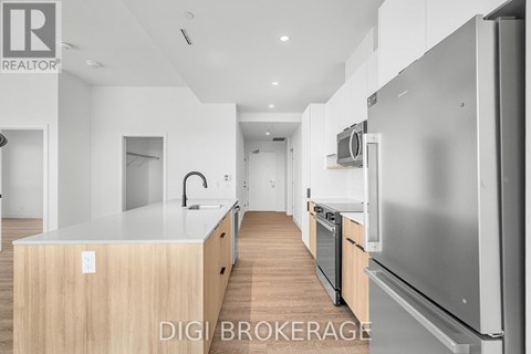 A modern kitchen with a stainless steel refrigerator and wooden countertops.