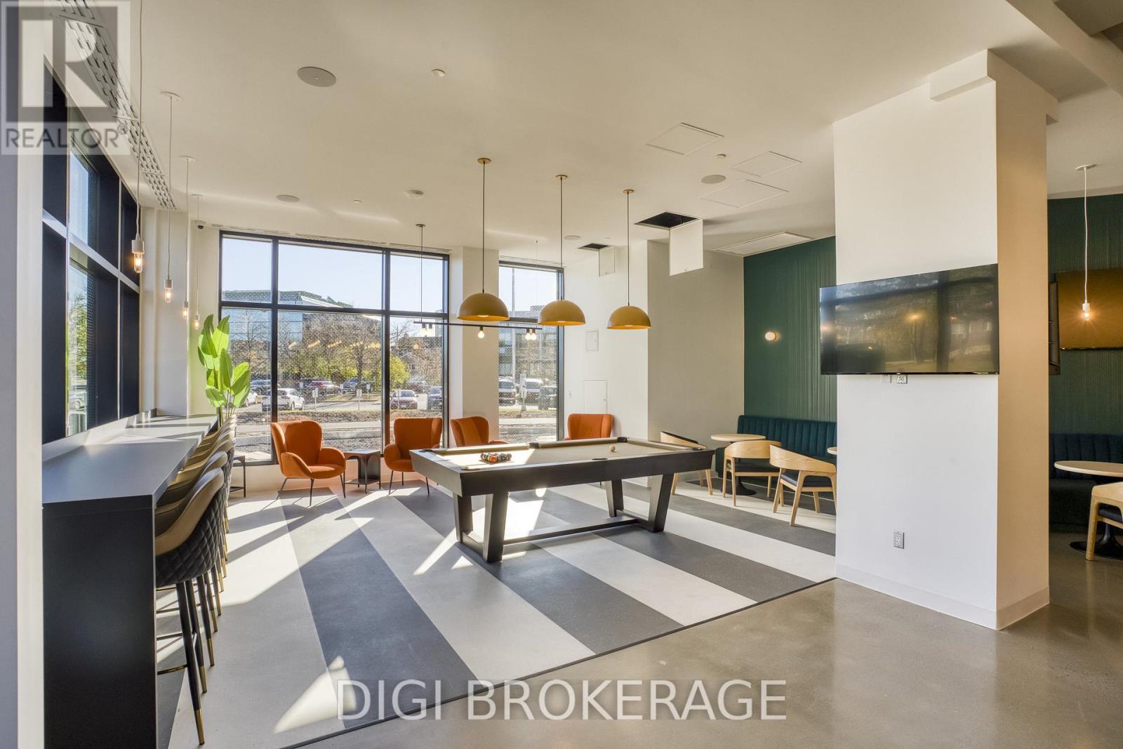 A modern dining room with a large table and chairs.