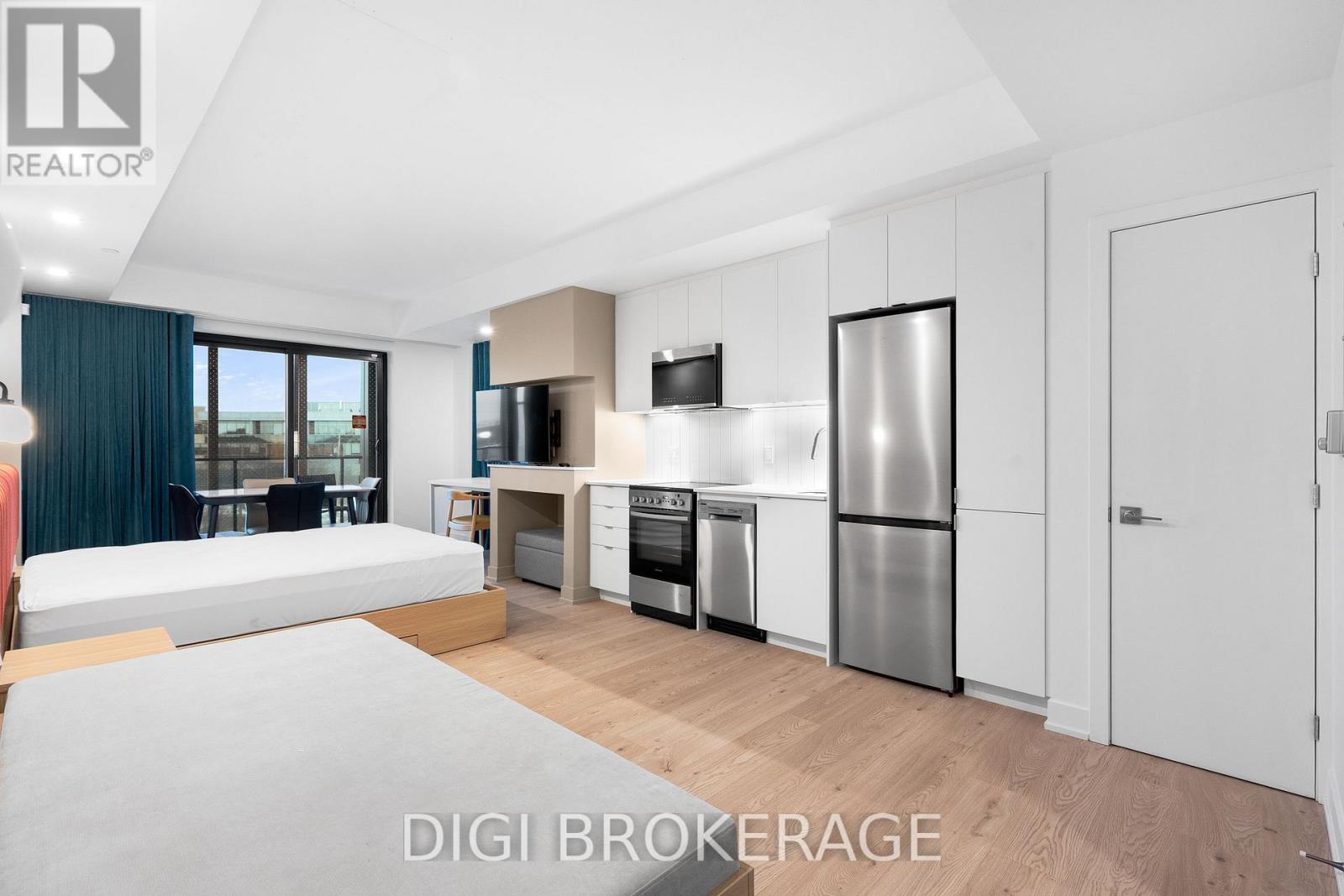 A modern kitchen with stainless steel appliances and white cabinets.