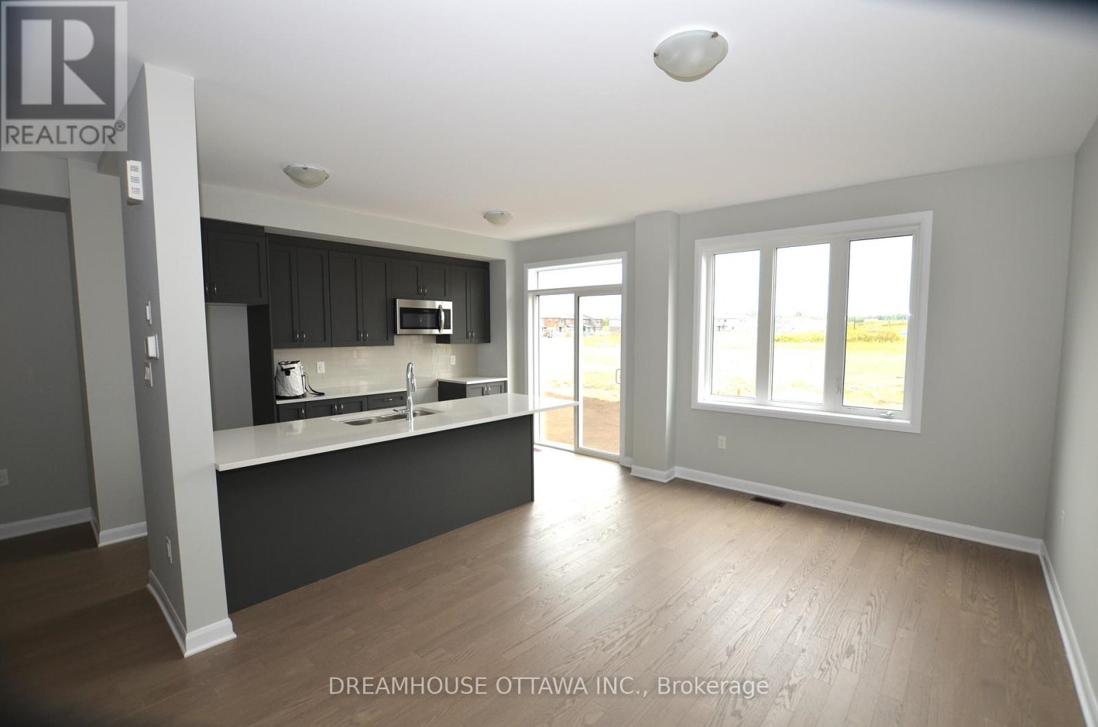 A kitchen with a counter and a microwave.