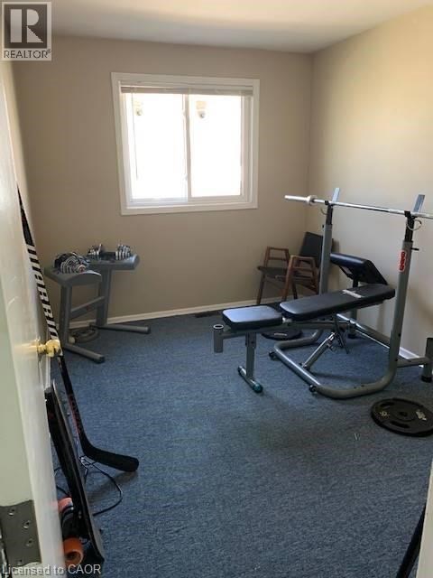 A home gym with a squat rack, bench, and weights.