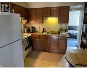 A kitchen with wooden cabinets and a white refrigerator.