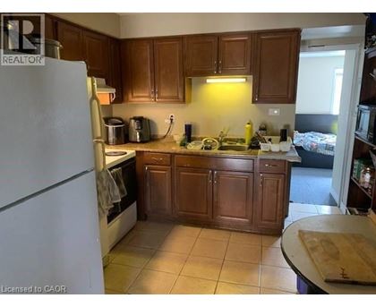 A kitchen with wooden cabinets and a white refrigerator.