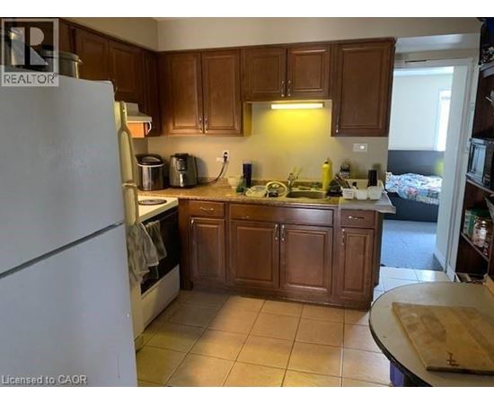 A kitchen with wooden cabinets and a white refrigerator.