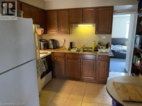 A kitchen with wooden cabinets and a white refrigerator.