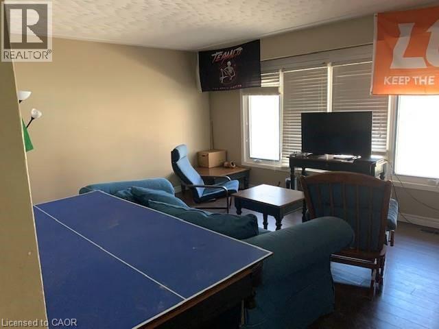 A living room with a blue table and a TV on the wall.