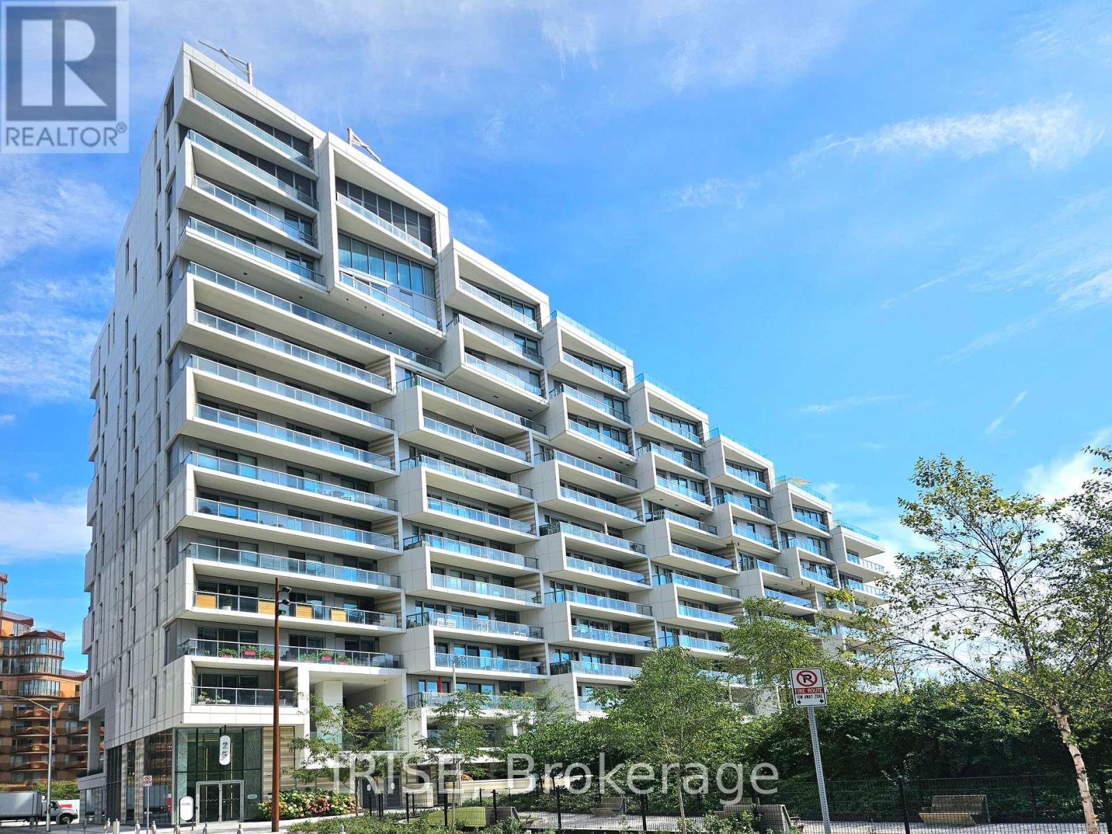 A modern multi-story building with a clear blue sky in the background.