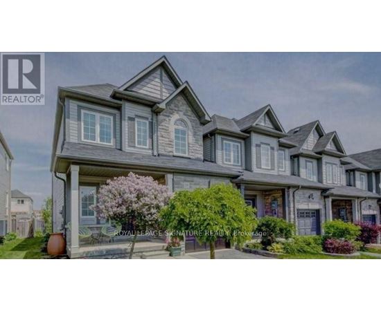 A large, multi-level house with a well-manicured front yard.
