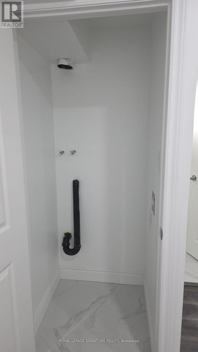 A white door with a black handle and a black pipe.