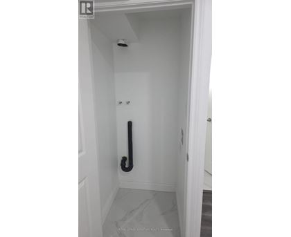A white door with a black handle and a black pipe.