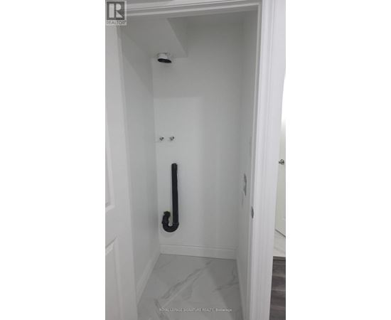 A white door with a black handle and a black pipe.