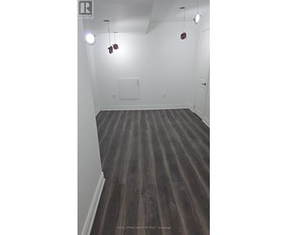 A room with wooden floors and white walls.