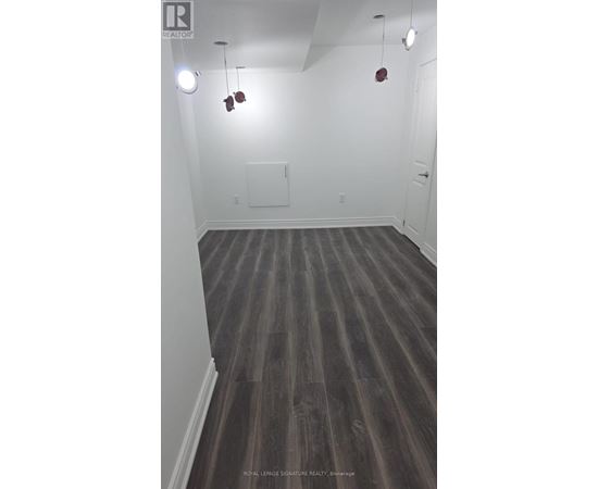 A room with wooden floors and white walls.