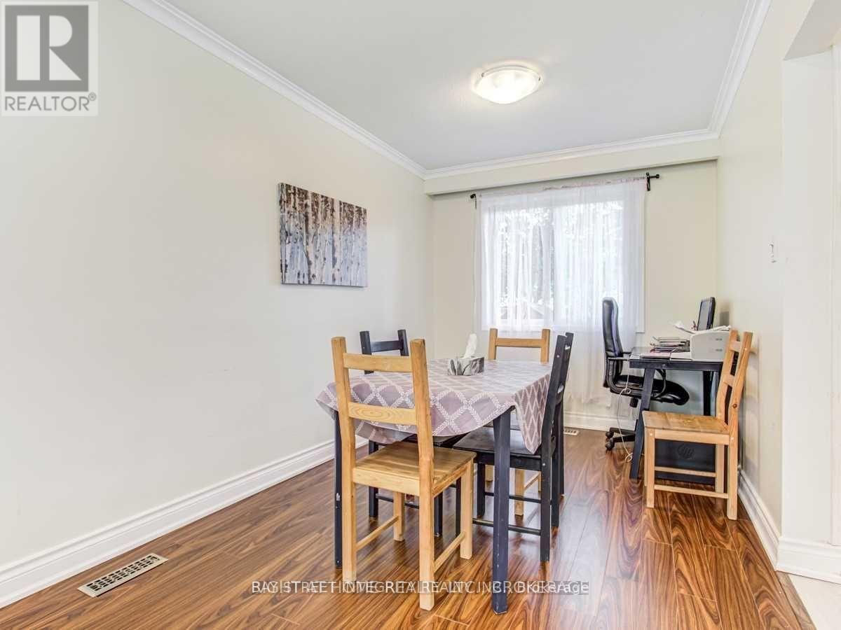 A dining room with a table set for four.