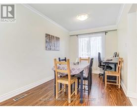 A dining room with a table set for four.
