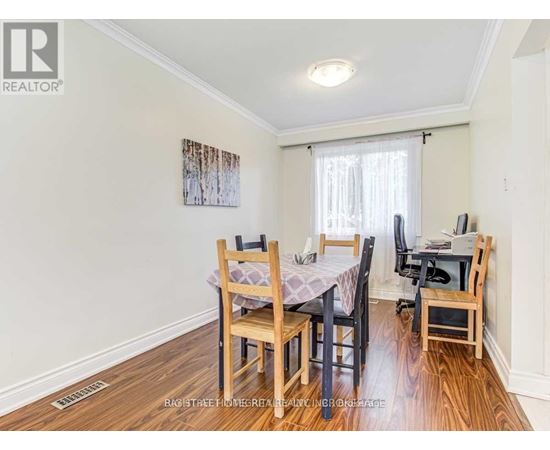 A dining room with a table set for four.