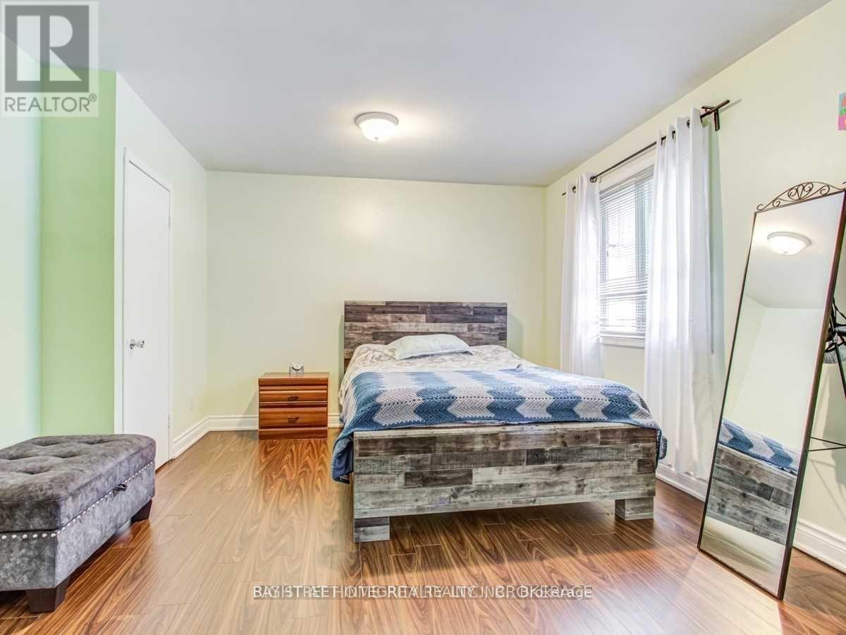 A bedroom with a bed, dresser, and mirror.