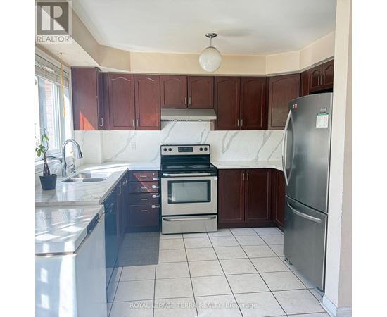 A kitchen with brown cabinets and a white counter top.