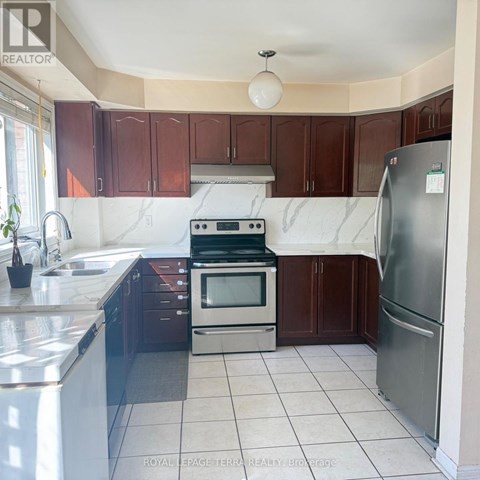 A kitchen with brown cabinets and a white counter top.