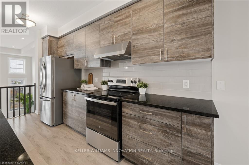 A modern kitchen with wooden cabinets and stainless steel appliances.