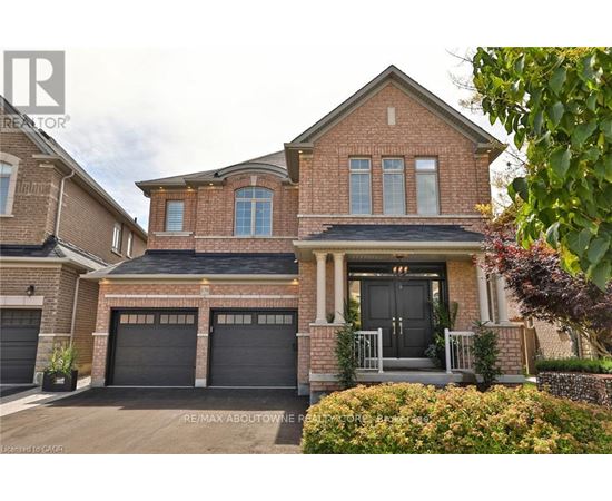 A brick house with a black front door and two garages.