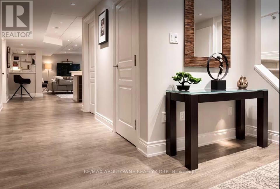 A well-lit hallway with a table and a mirror on the wall.