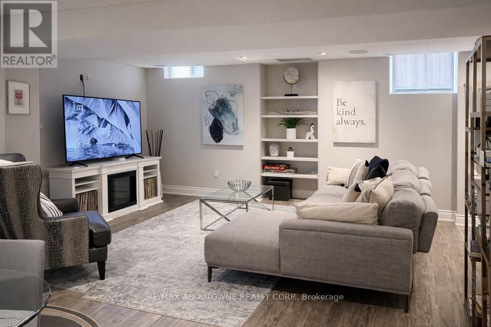 A living room with a grey couch, a television, and a coffee table.