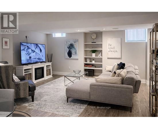 A living room with a grey couch, a television, and a coffee table.