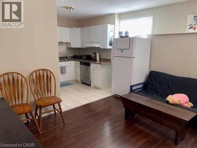 A kitchen with white cabinets and a refrigerator.