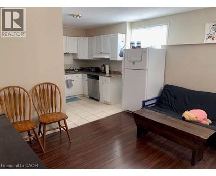 A kitchen with white cabinets and a refrigerator.