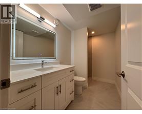 A bathroom with a sink, mirror, and toilet.