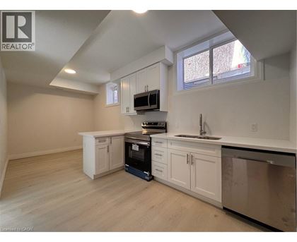 A kitchen with white cabinets and a black oven.