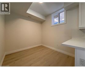 A room with a window and wooden flooring.