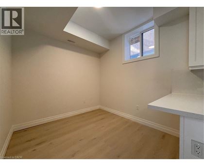 A room with a window and wooden flooring.