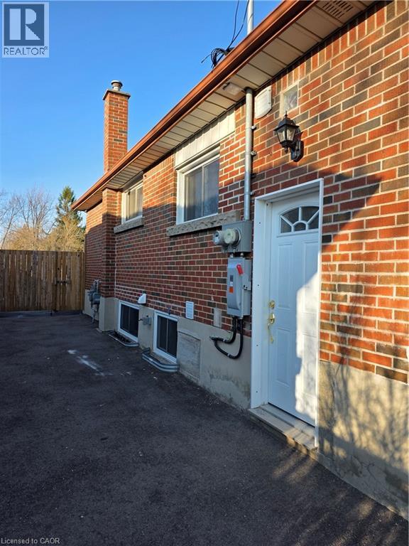 A red brick house with a white door and windows.