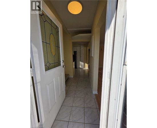 A hallway with a white door and a glass window.