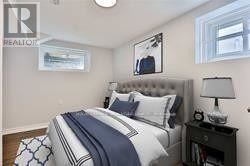 A bedroom with a bed, nightstand, and lamp.