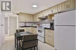 A kitchen with a table and chairs in it.