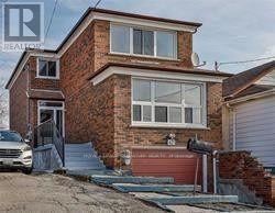 A house with a red brick exterior and a white garage door.