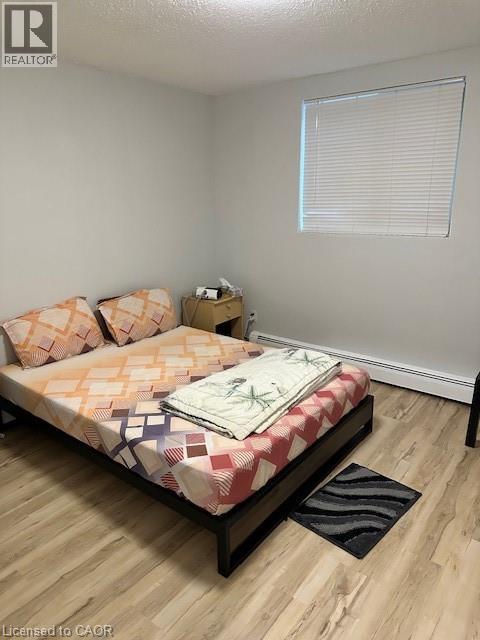 A bedroom with a bed, pillows, and a nightstand.