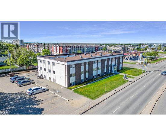 A large building with a parking lot in front of it.