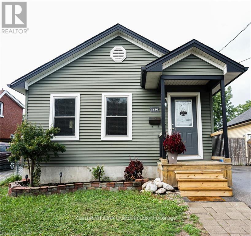 A grey house with a white door and windows.