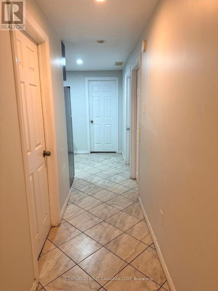 A hallway with tiled floors and white doors.