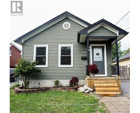 A grey house with a white door and windows.